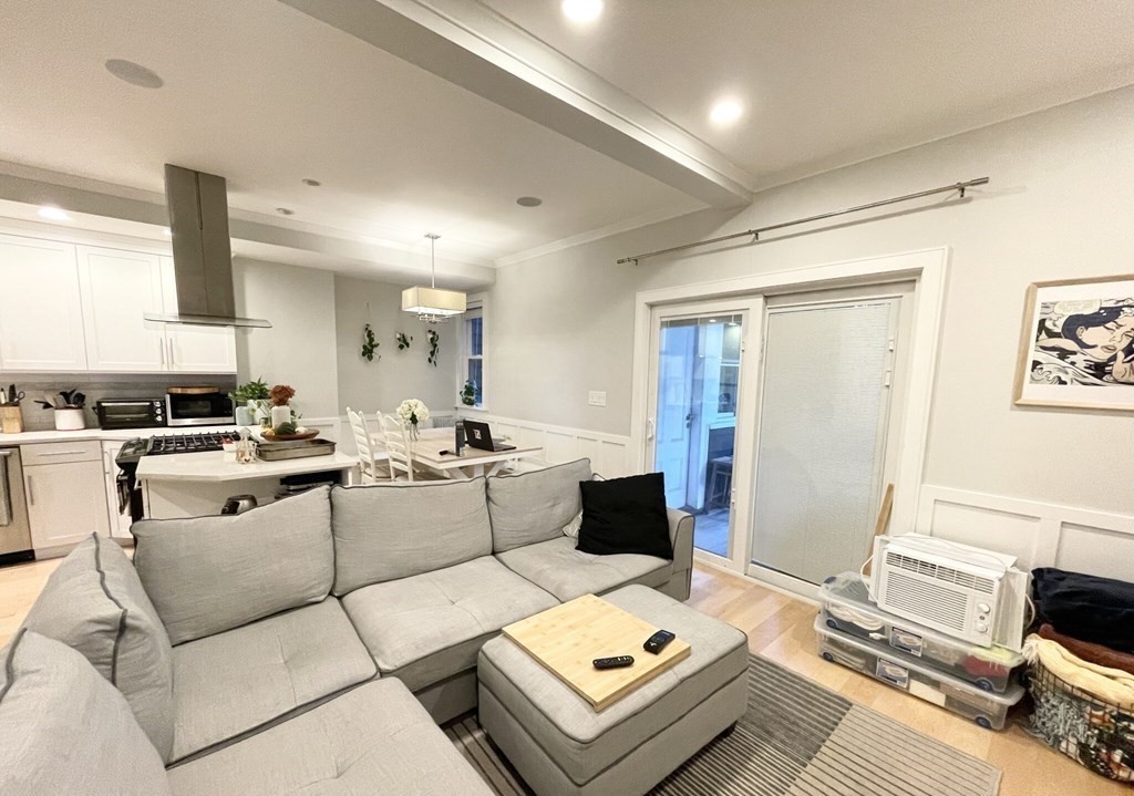 108 Buttonwood Street, Unit 1 Boston, MA 02125 - Photo 6 of 12 a living room with furniture and a table