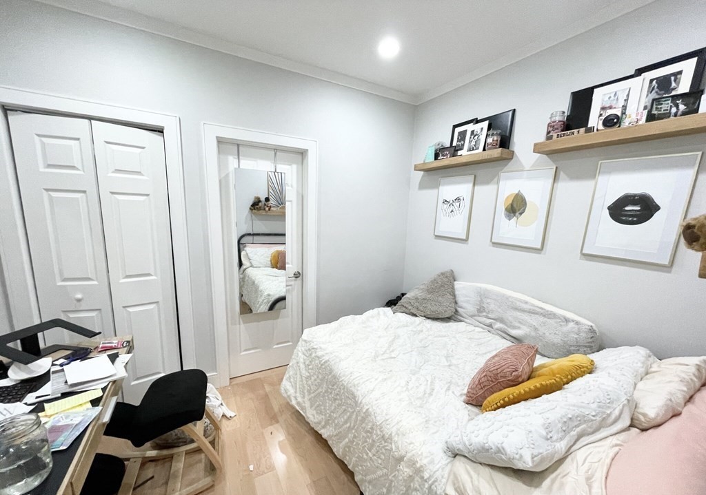 108 Buttonwood Street, Unit 1 Boston, MA 02125 - Photo 8 of 12 a bedroom with a bed and furniture