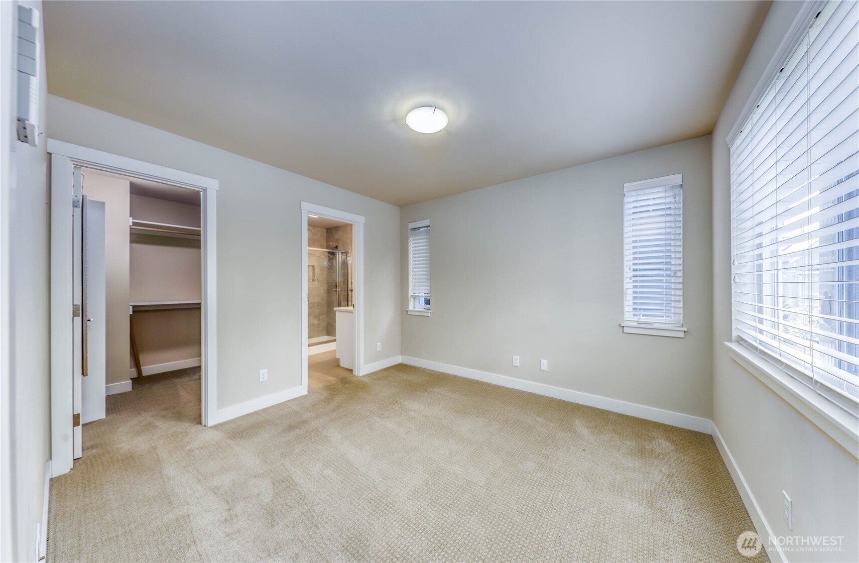 690 Wintersweet Road Northeast Bainbridge Island, WA 98110 - Photo 18 of 23 an empty room with windows and closet