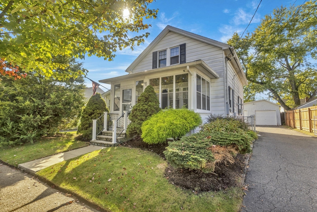 274 Abbott Street Springfield, MA 01118 - Photo 1 of 42 a front view of a house with garden