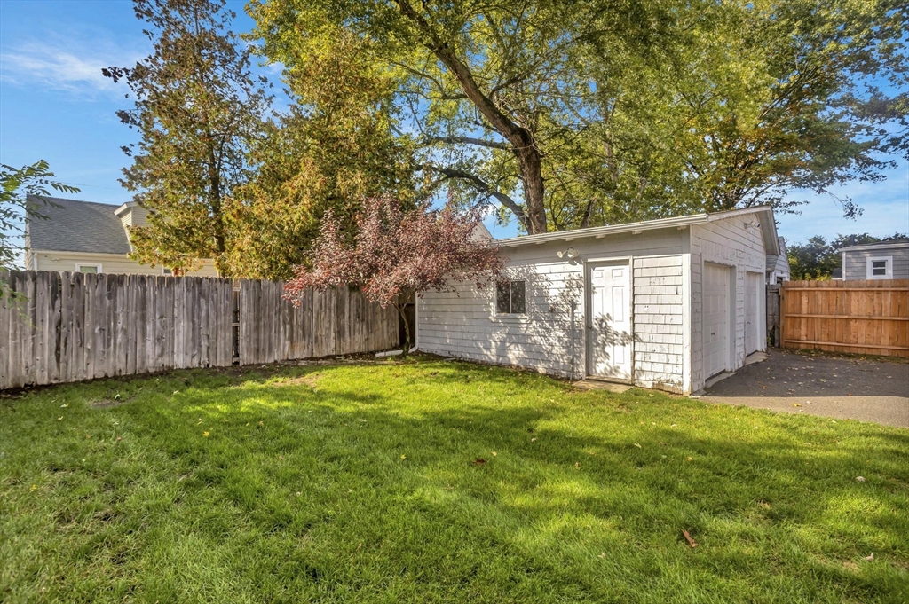 274 Abbott Street Springfield, MA 01118 - Photo 36 of 42 a view of a backyard with large trees and wooden fence