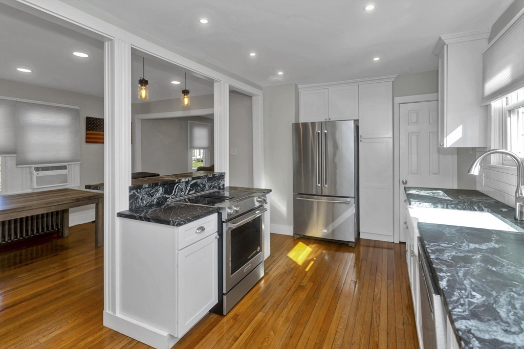 274 Abbott Street Springfield, MA 01118 - Photo 6 of 42 a kitchen with stainless steel appliances granite countertop a stove and a refrigerator
