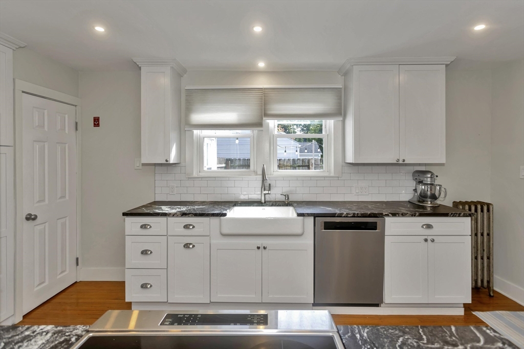 274 Abbott Street Springfield, MA 01118 - Photo 9 of 42 a kitchen with stainless steel appliances granite countertop a stove a sink and a microwave