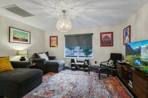 a living room with furniture a rug and a window