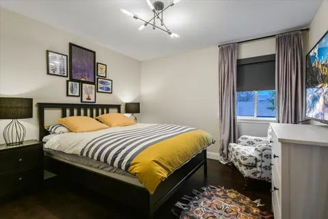 a bedroom with a bed and a chandelier