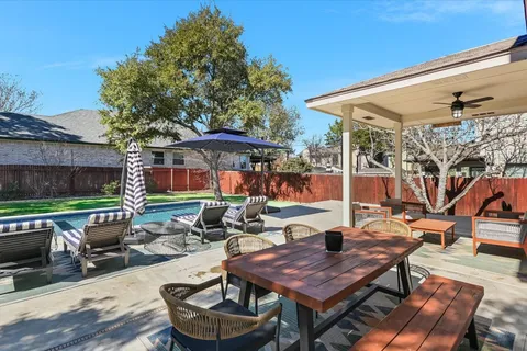 a patio with tables and chairs