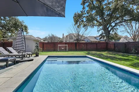 a view of swimming pool with a yard