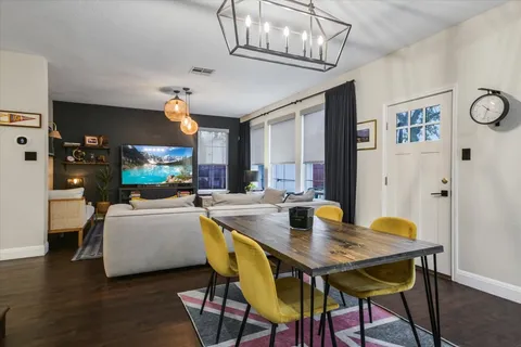 a view of a dining room with furniture and a chandelier