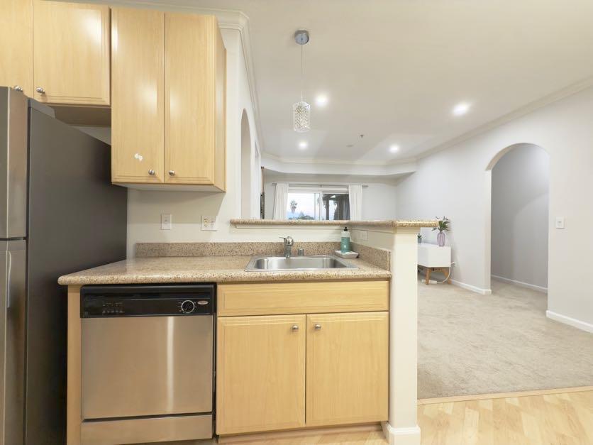 801 South Winchester Boulevard, Unit 4310 San Jose, CA 95128 - Photo 13 of 38 a kitchen with a sink a stove cabinets and a refrigerator
