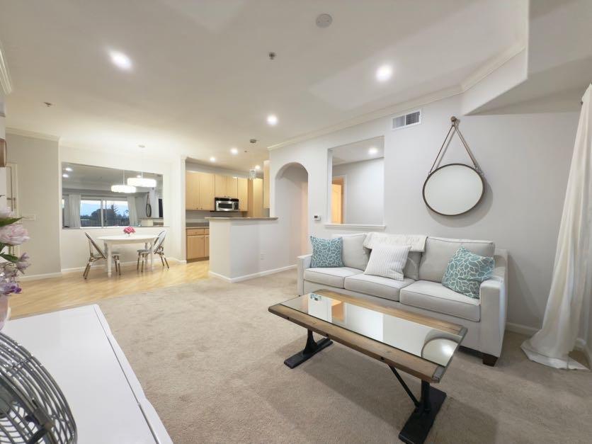 801 South Winchester Boulevard, Unit 4310 San Jose, CA 95128 - Photo 14 of 38 a living room with furniture and a wooden floor