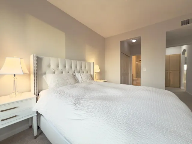 a room with a bed and a view of bathroom