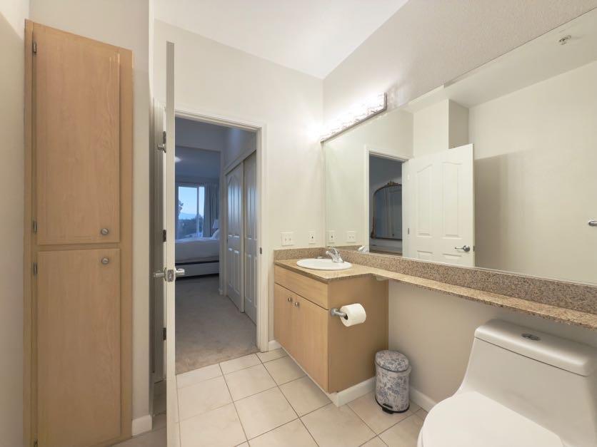 801 South Winchester Boulevard, Unit 4310 San Jose, CA 95128 - Photo 21 of 38 a spacious bathroom with a granite countertop sink and a mirror