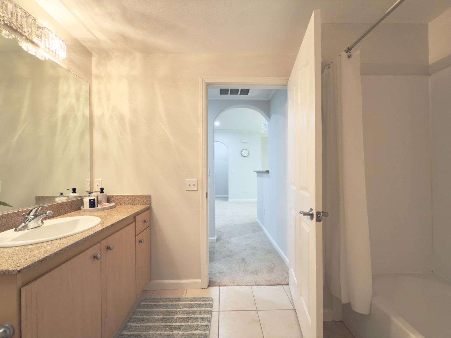 801 South Winchester Boulevard, Unit 4310 San Jose, CA 95128 - Photo 25 of 38 a spacious bathroom with a double vanity sink and a mirror