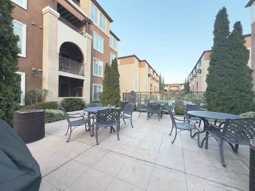 801 South Winchester Boulevard, Unit 4310 San Jose, CA 95128 - Photo 30 of 38 a view of a patio with dining table and chairs