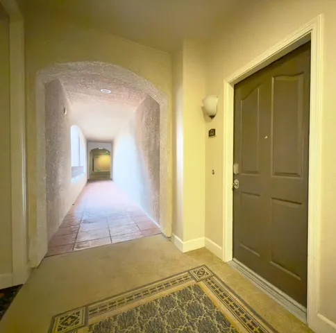 a view of a dining room with furniture and a chandelier