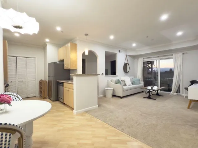 a view of kitchen with refrigerator microwave and wooden floor