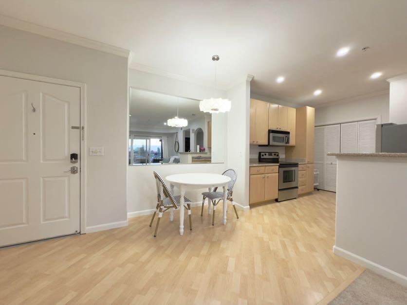 801 South Winchester Boulevard, Unit 4310 San Jose, CA 95128 - Photo 8 of 38 a view of kitchen with refrigerator microwave and wooden floor