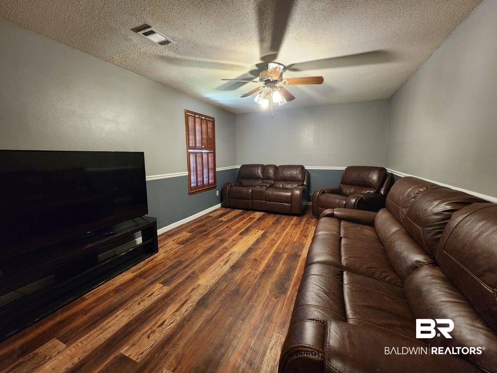 640 Horseshoe Road Brewton, AL 36426 - Photo 7 of 22 Living room with ceiling fan, a textured ceiling, and dark hardwood / wood-style flooring
