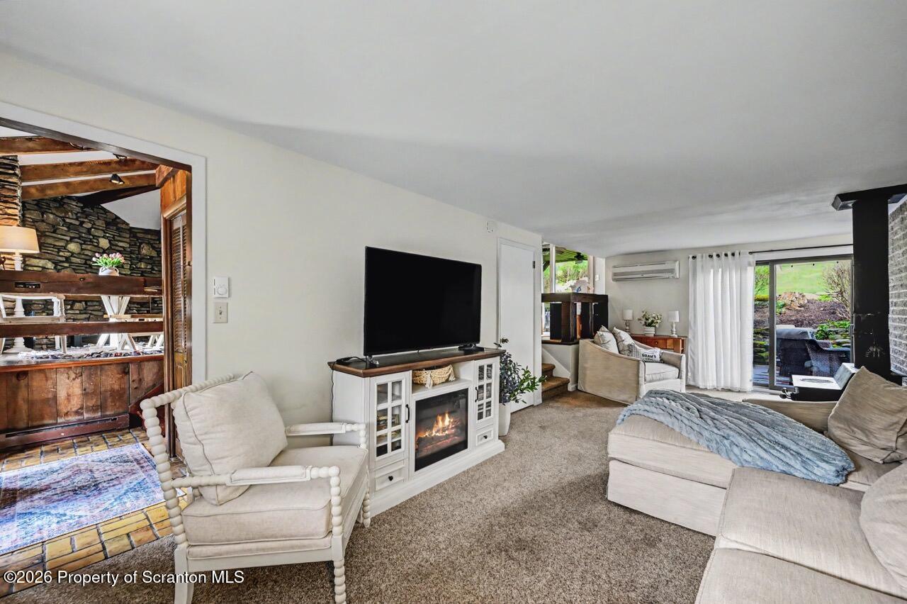 719 Scott Road Clarks Summit, PA 18411 - Photo 17 of 51 a living room with furniture and a flat screen tv