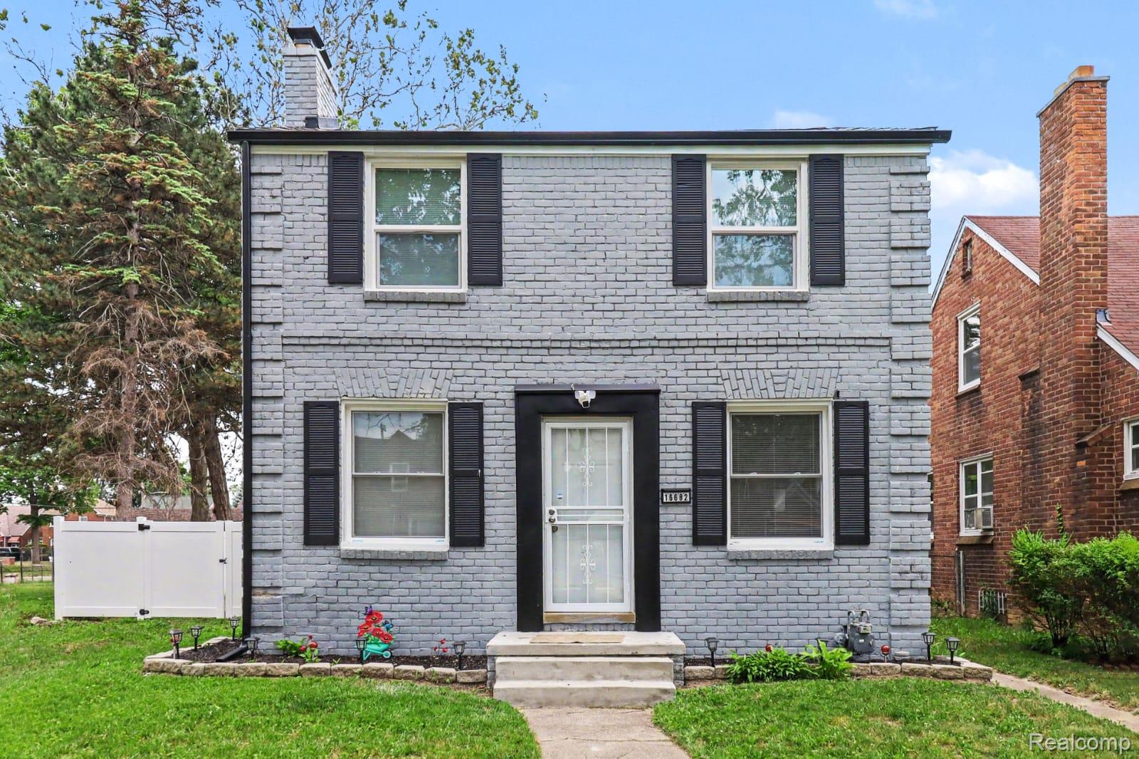 16682 Robson Street Detroit, MI 48235 - Photo 1 of 19 Gray brick exterior with black shutters and trim