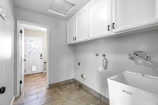 a bathroom with a granite countertop toilet a sink and a mirror