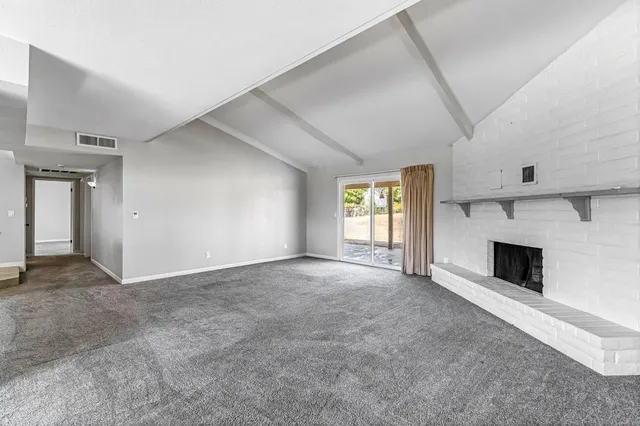 a view of empty room with a fireplace