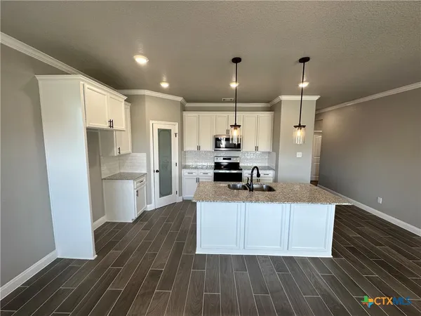 a kitchen with sink and mirror