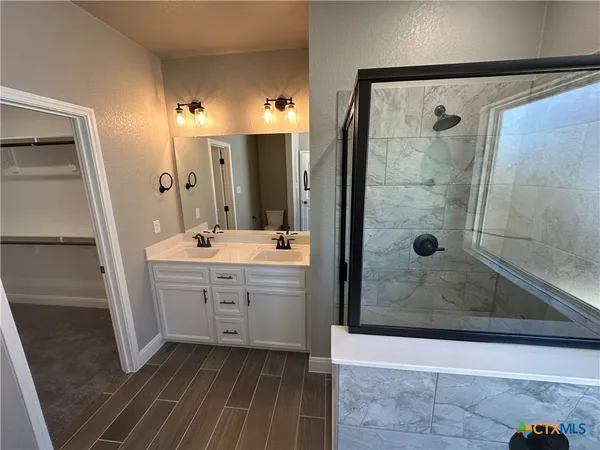 a bathroom with a bathtub and shower