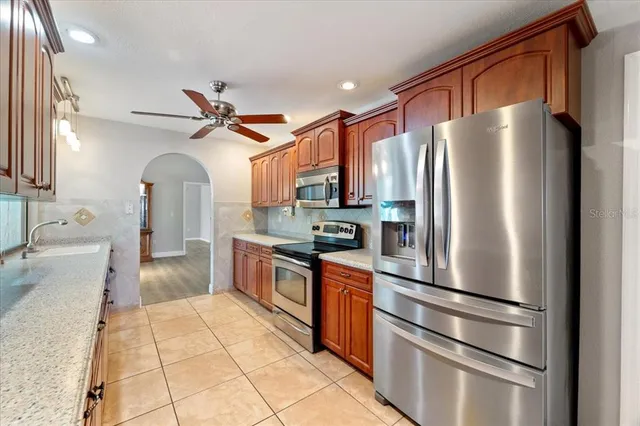 a bathroom with a granite countertop sink and mirror