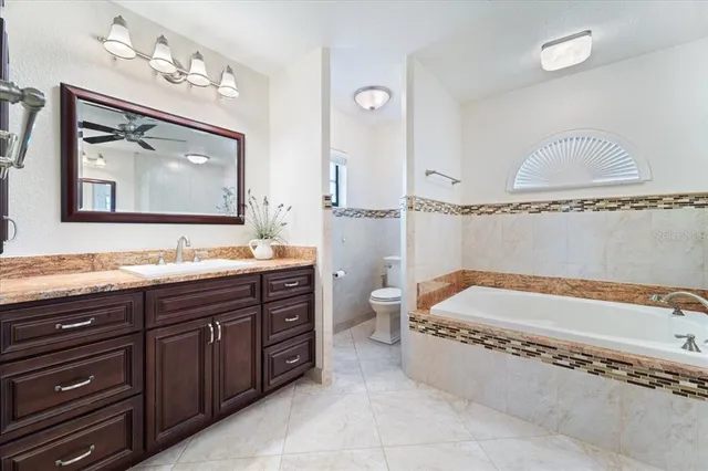 a bathroom with a tub a sink and mirror
