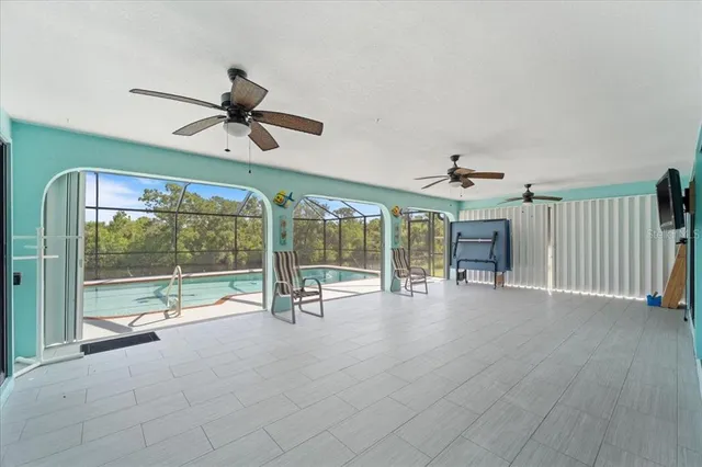 a living room with furniture and a ceiling fan