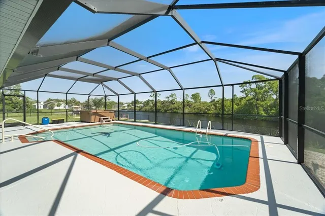 a view of white house with a swimming pool