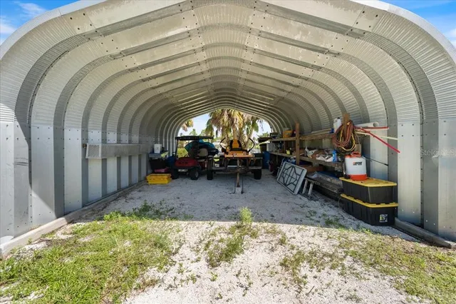 an aerial view of a multi story residential apartment building with a yard and plants