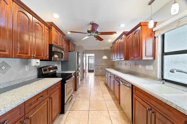 a kitchen with stainless steel appliances granite countertop a refrigerator and a sink