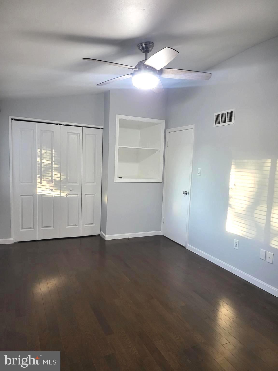 6556 Frietchie Row Columbia, MD 21045 - Photo 17 of 21 an empty room with wooden floor and windows