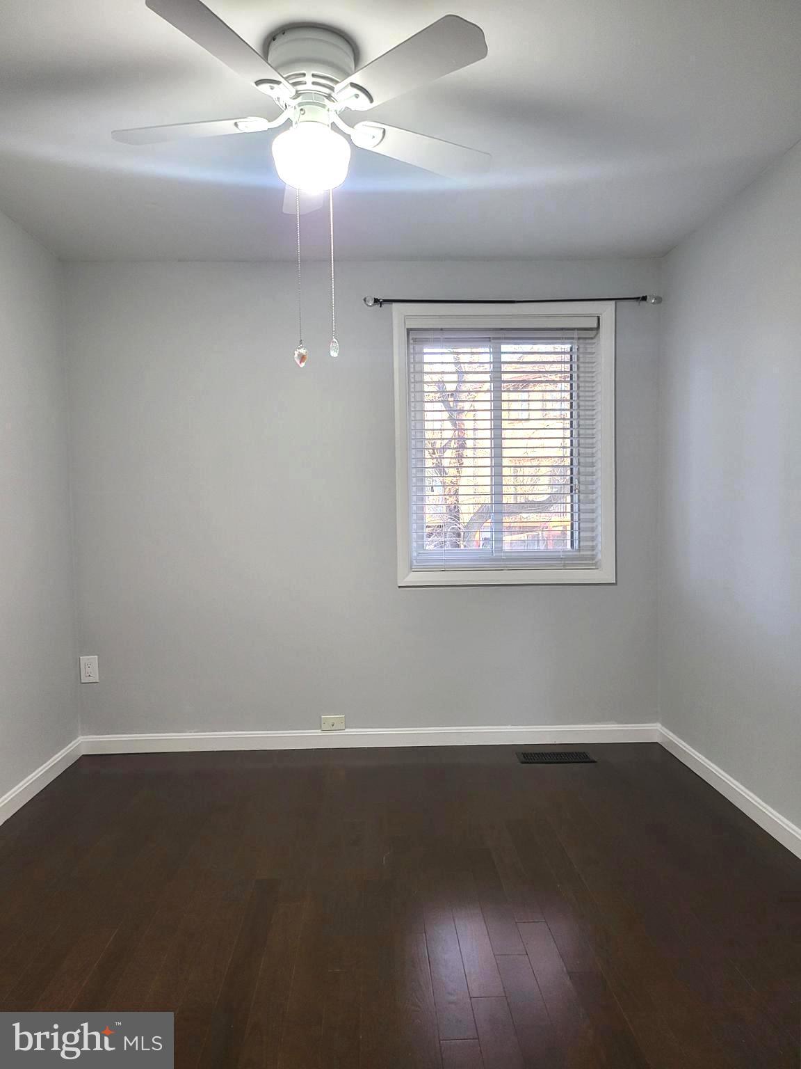 6556 Frietchie Row Columbia, MD 21045 - Photo 19 of 21 en empty room with wooden floor and windows