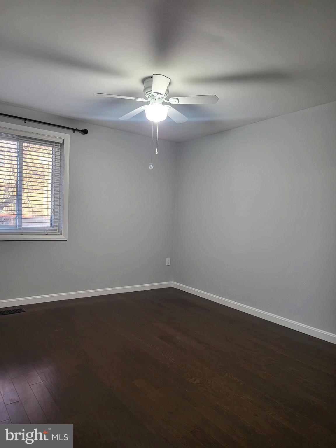 6556 Frietchie Row Columbia, MD 21045 - Photo 20 of 21 an empty room with wooden floor fan and windows