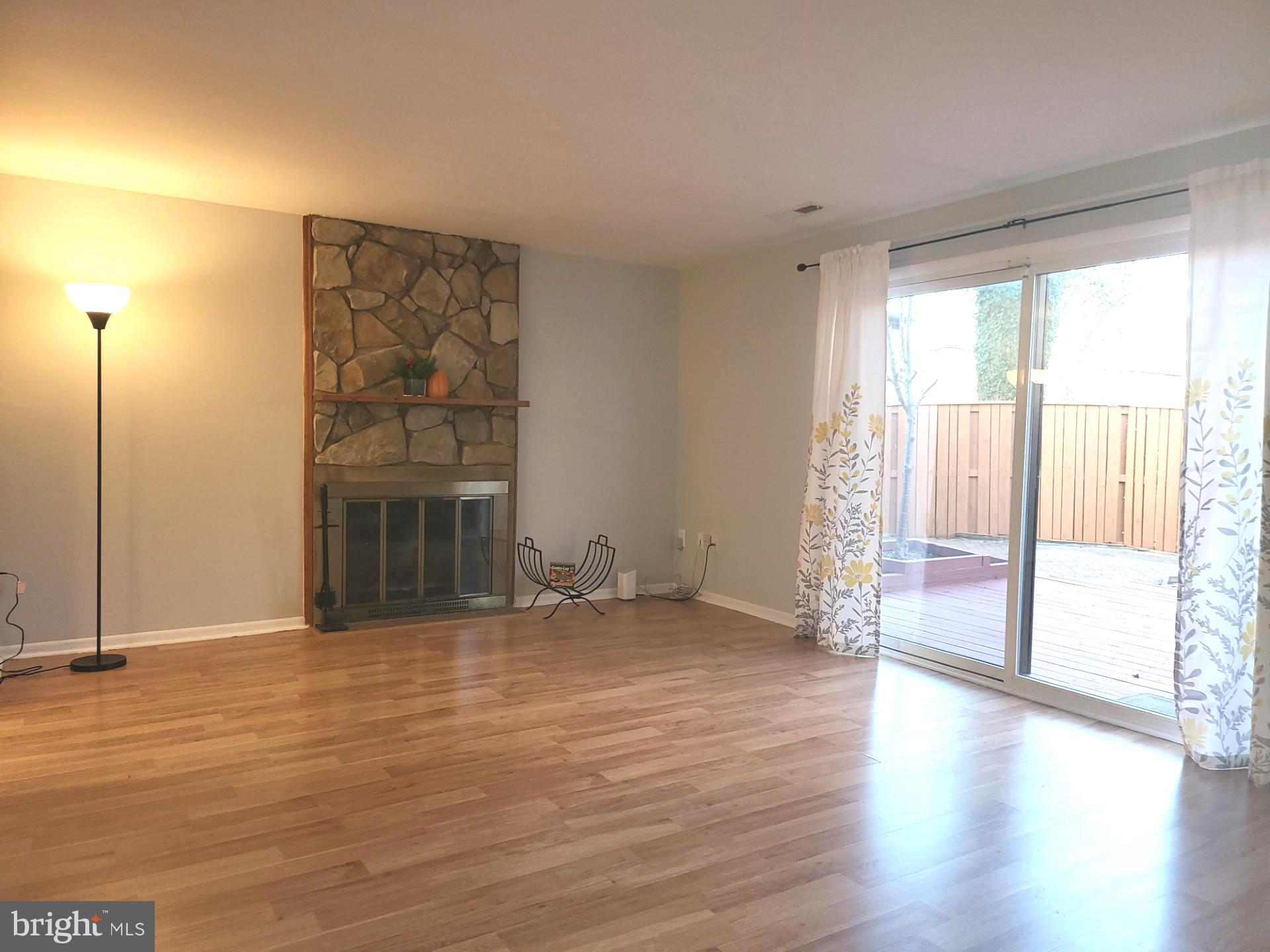 6556 Frietchie Row Columbia, MD 21045 - Photo 5 of 21 a view of empty room with wooden floor and fireplace