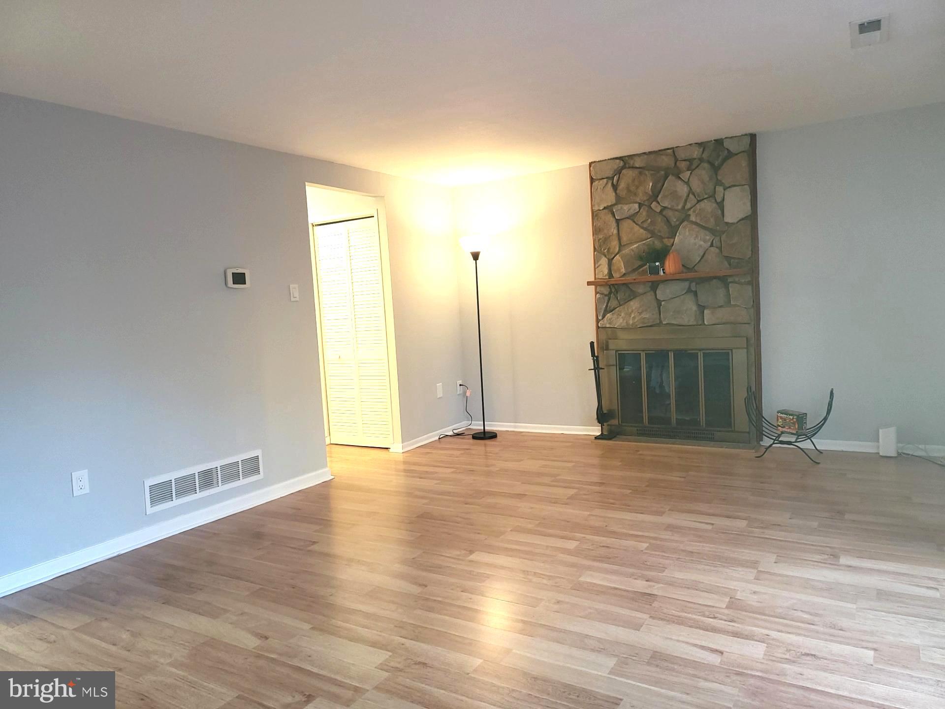 6556 Frietchie Row Columbia, MD 21045 - Photo 7 of 21 a view of an empty room with wooden floor and a window