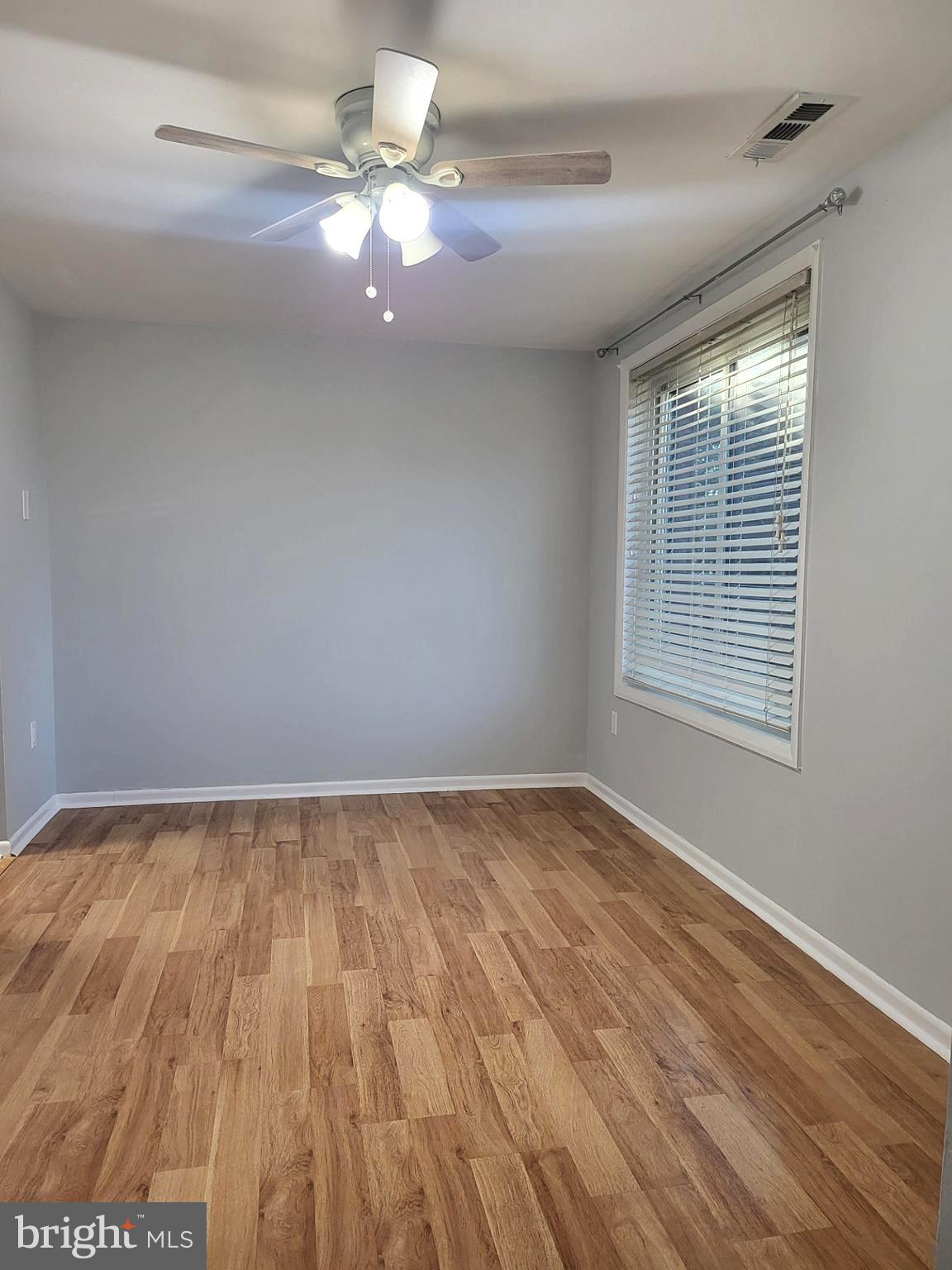 6556 Frietchie Row Columbia, MD 21045 - Photo 10 of 21 wooden floor in an empty room with a window