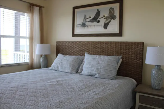 a bedroom with a bed and a window