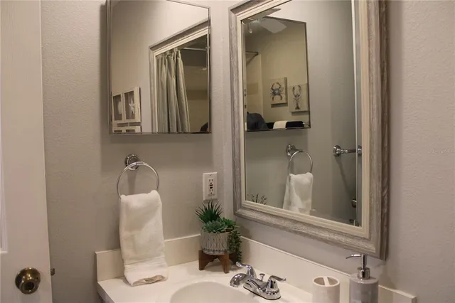 a bathroom with a sink and mirror with toilet