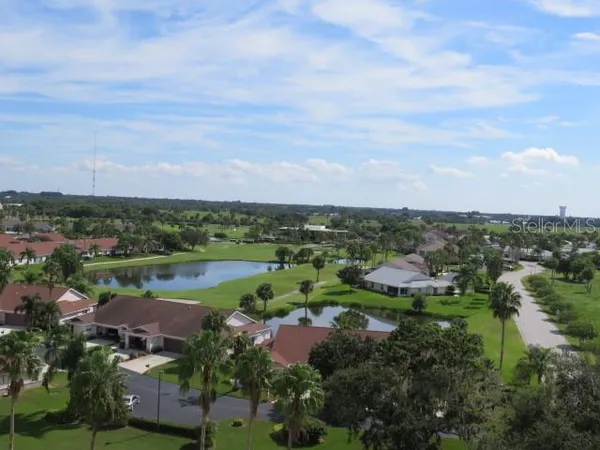 an aerial view of a city with lots of residential buildings lake and ocean view
