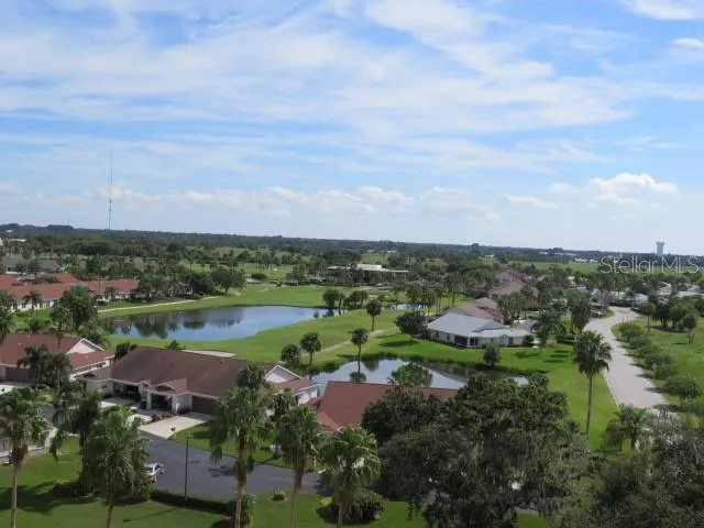 an aerial view of a city with lots of residential buildings lake and ocean view