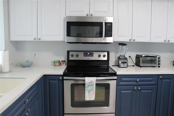 a kitchen with stainless steel appliances a stove a microwave and cabinets