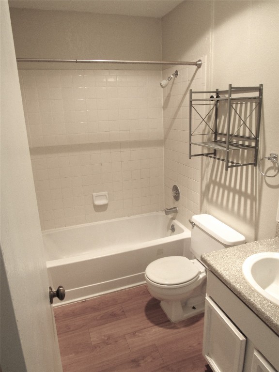 7812 West Gate Boulevard Austin, TX 78745 - Photo 11 of 13 a bathroom with a granite countertop bathtub shower sink vanity and toilet