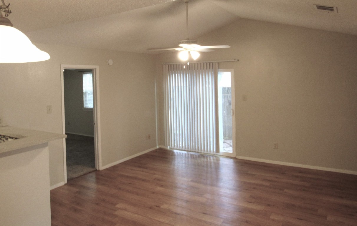 7812 West Gate Boulevard Austin, TX 78745 - Photo 5 of 13 an empty room with wooden floor and windows