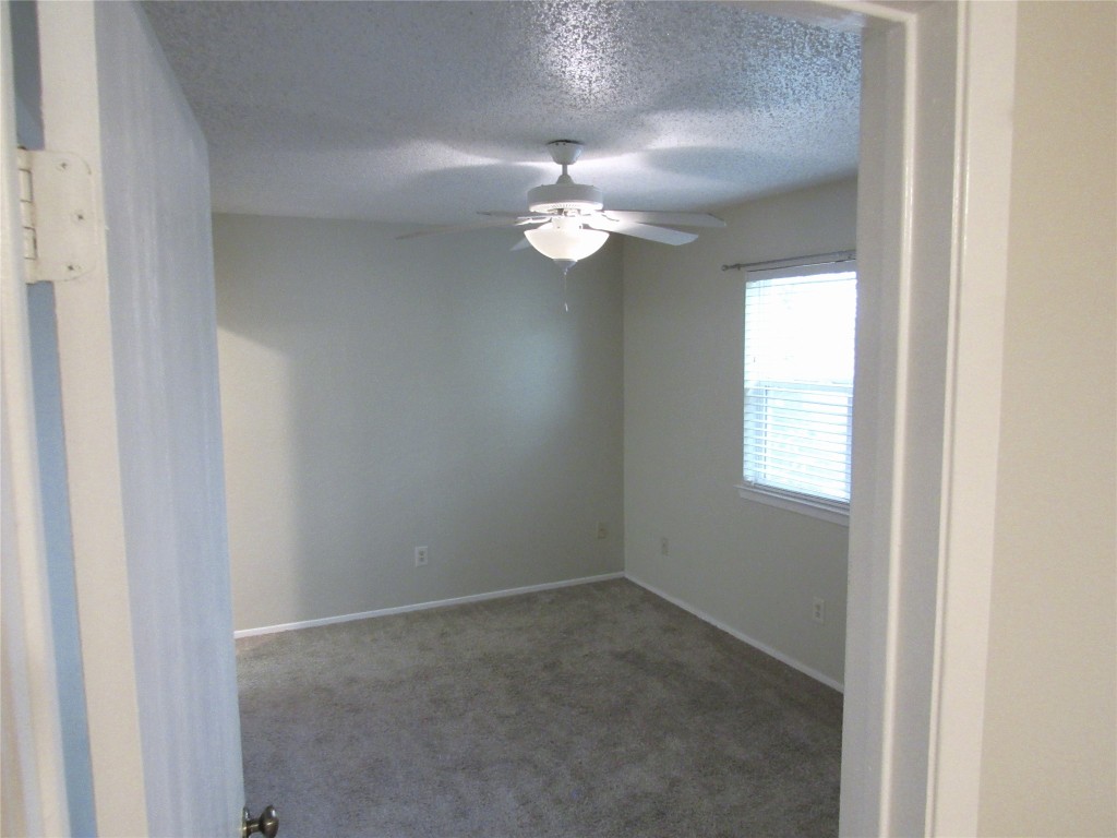 7812 West Gate Boulevard Austin, TX 78745 - Photo 8 of 13 an empty room with windows and fan
