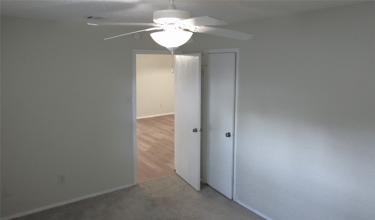 7812 West Gate Boulevard Austin, TX 78745 - Photo 9 of 13 a view of a chandelier fan and hardwood floor