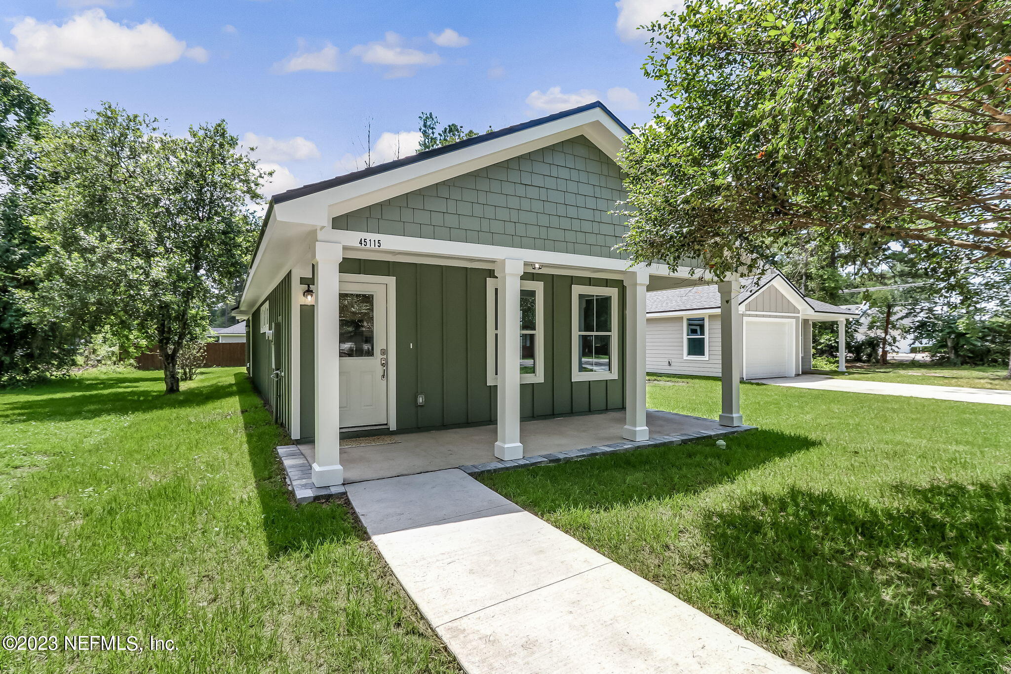 a view of a house with a yard and garden